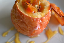 close-up view of a freshly baked dinner cheese and apple drizzled with honey