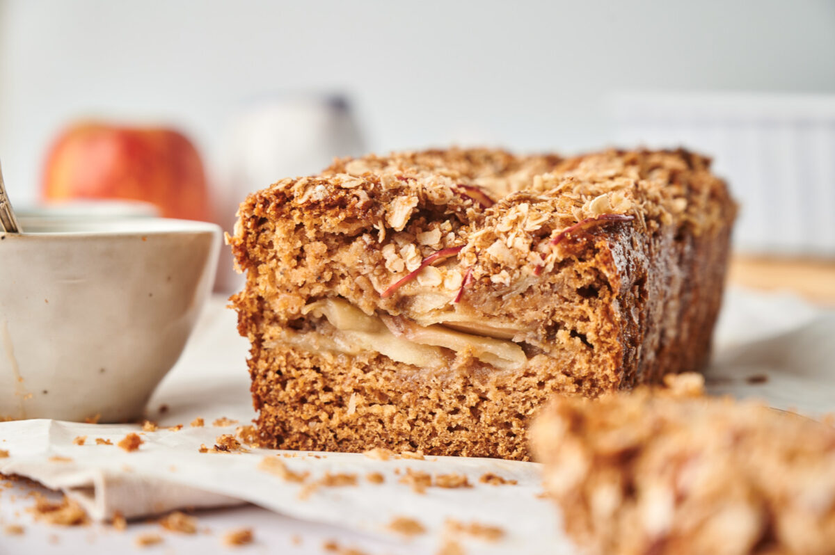 A loaf of healthy apple bread, sliced down the middle.