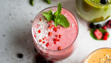 A raspberry smoothie garnished with mint.