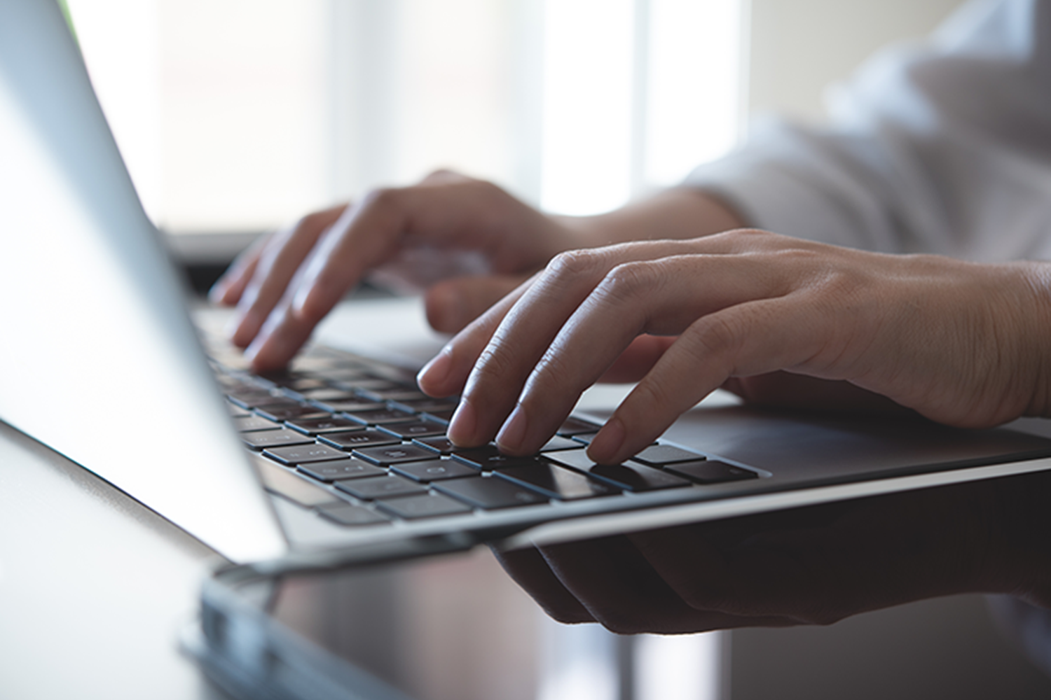 hands on a laptop