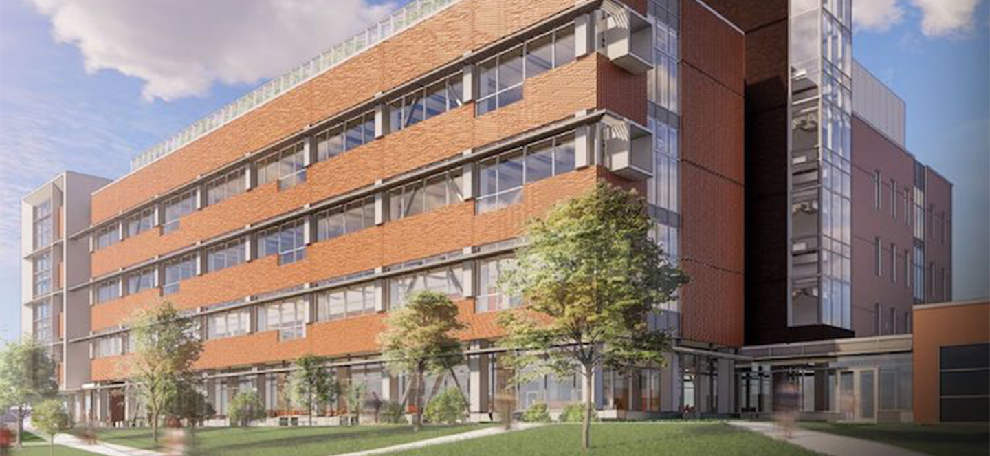 A rendering of the new research facility on the campus of Michigan State University. It is a multi-story building wrapped in brick and glass. 